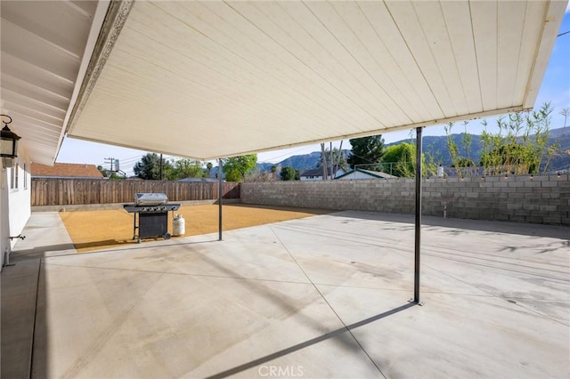 15021 Eureka St, Lake Elsinore, CA 92530 - view of patio with grilling area, a mountain view, and a fenced backyard