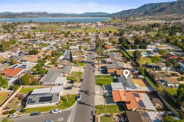 drone / aerial view with a water and mountain view and a residential view