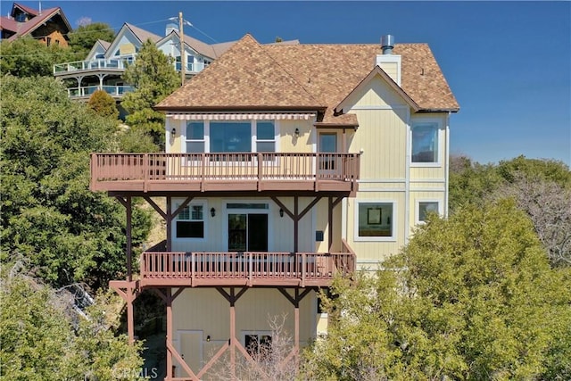 29083 Mammoth Dr, Lake Arrowhead, CA 92352 - rear view of property featuring a wooden deck, roof with shingles, and a chimney