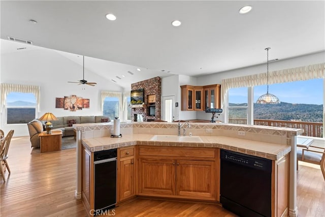 29083 Mammoth Dr, Lake Arrowhead, CA 92352 - kitchen featuring black dishwasher, open floor plan, light wood-style floors, tile countertops, and recessed lighting
