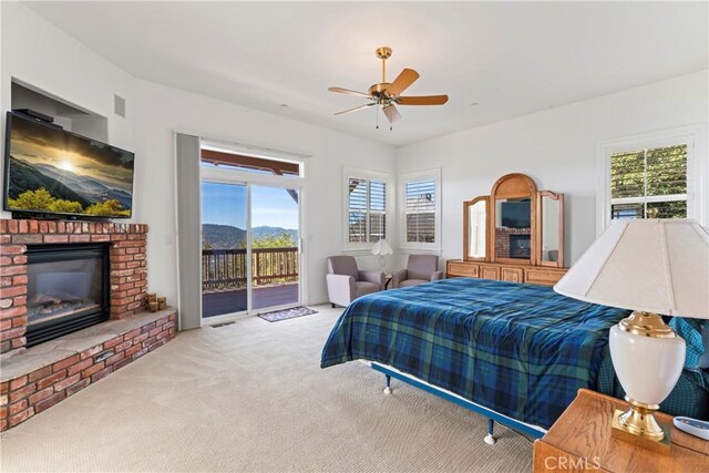 29083 Mammoth Dr, Lake Arrowhead, CA 92352 - carpeted bedroom with access to outside, multiple windows, a fireplace, and a ceiling fan