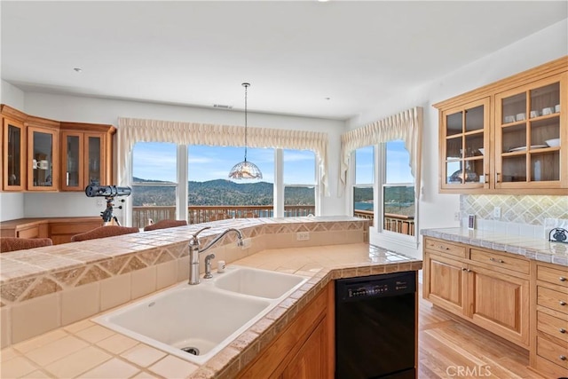 29083 Mammoth Dr, Lake Arrowhead, CA 92352 - kitchen with black dishwasher, plenty of natural light, backsplash, and hanging light fixtures