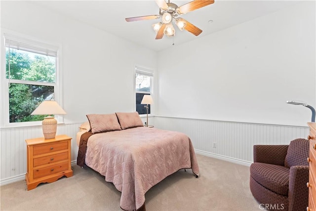 29083 Mammoth Dr, Lake Arrowhead, CA 92352 - bedroom featuring a wainscoted wall, light colored carpet, and ceiling fan