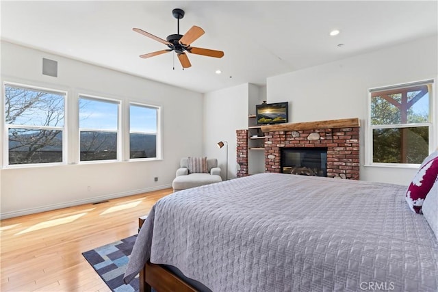 29083 Mammoth Dr, Lake Arrowhead, CA 92352 - bedroom featuring multiple windows, wood finished floors, recessed lighting, a fireplace, and a ceiling fan