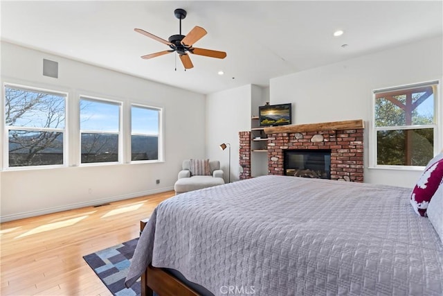 29083 Mammoth Dr, Lake Arrowhead, CA 92352 - bedroom featuring wood finished floors, recessed lighting, a fireplace, and a ceiling fan