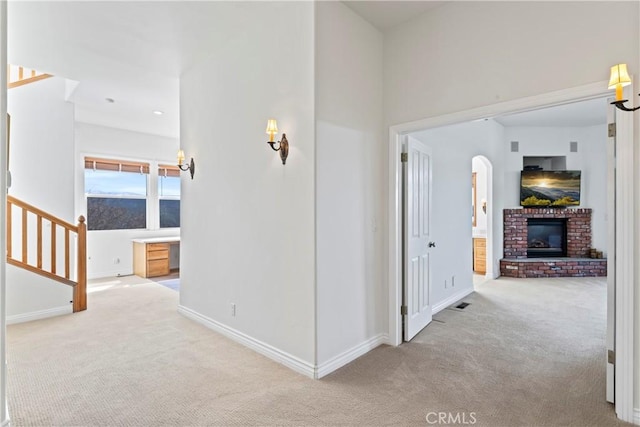 29083 Mammoth Dr, Lake Arrowhead, CA 92352 - hall with carpet flooring, arched walkways, and stairway