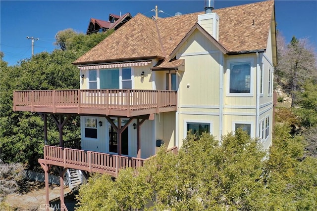29083 Mammoth Dr, Lake Arrowhead, CA 92352 - rear view of property with a shingled roof, a deck, and a chimney