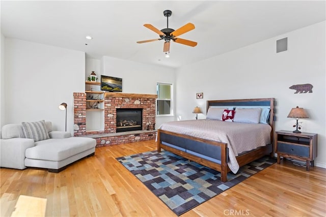 29083 Mammoth Dr, Lake Arrowhead, CA 92352 - bedroom with wood finished floors, recessed lighting, a ceiling fan, and a brick fireplace