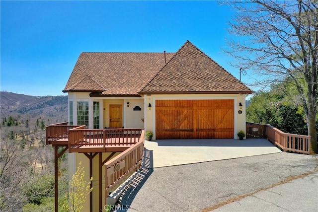 29083 Mammoth Dr, Lake Arrowhead, CA 92352 - view of front of property with a garage, roof with shingles, driveway, and a mountain view