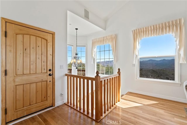 29083 Mammoth Dr, Lake Arrowhead, CA 92352 - foyer entrance with a chandelier and wood finished floors