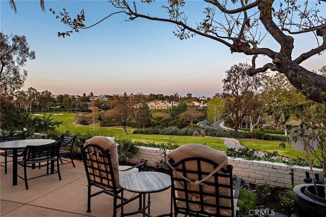 view of patio featuring outdoor dining space and golf course view