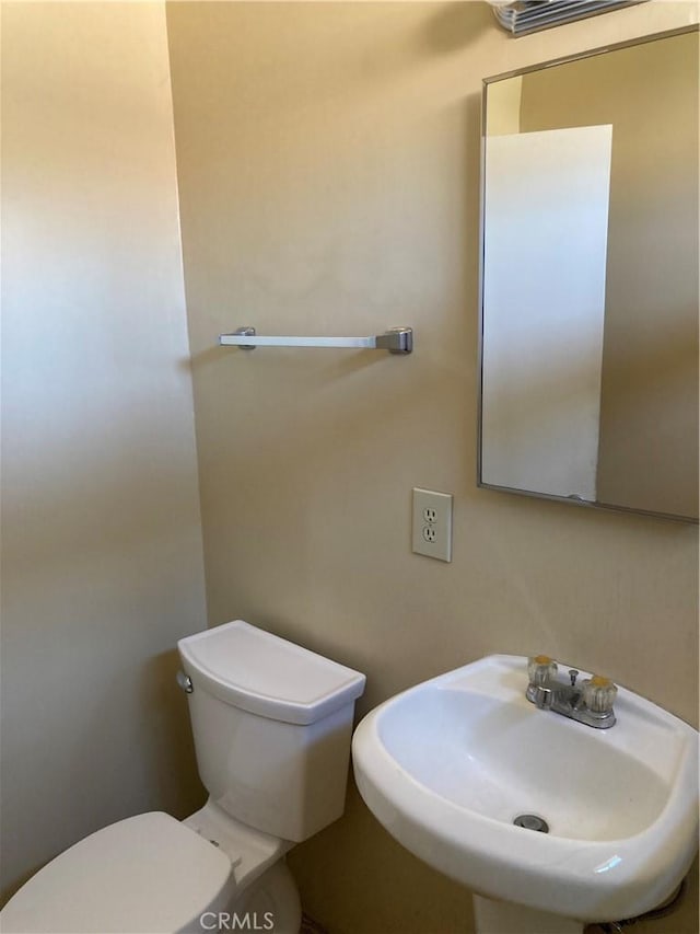 half bathroom with a sink and toilet