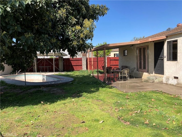 view of yard with a patio area, a fenced backyard, a fenced in pool, and french doors