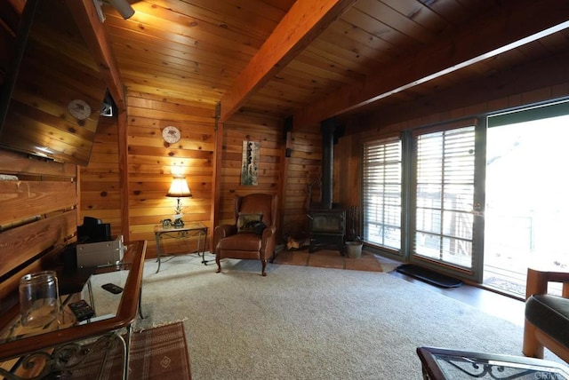 206 Cedar Ln, Sugarloaf, CA 92386 - carpeted living area with a wood stove, wooden walls, wooden ceiling, and beam ceiling