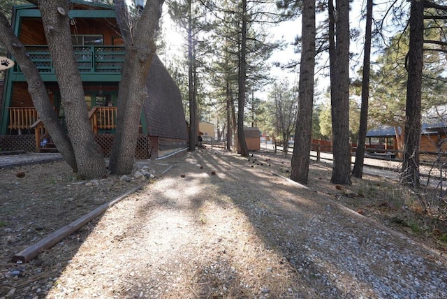 206 Cedar Ln, Sugarloaf, CA 92386 - view of yard featuring an attached garage, fence, and driveway