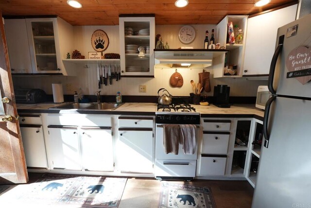206 Cedar Ln, Sugarloaf, CA 92386 - kitchen with freestanding refrigerator, open shelves, under cabinet range hood, wooden ceiling, and a sink