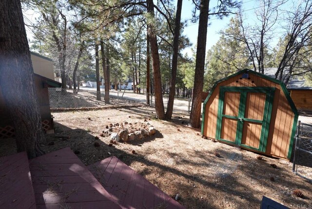 206 Cedar Ln, Sugarloaf, CA 92386 - view of yard with a shed, an outdoor structure, and fence