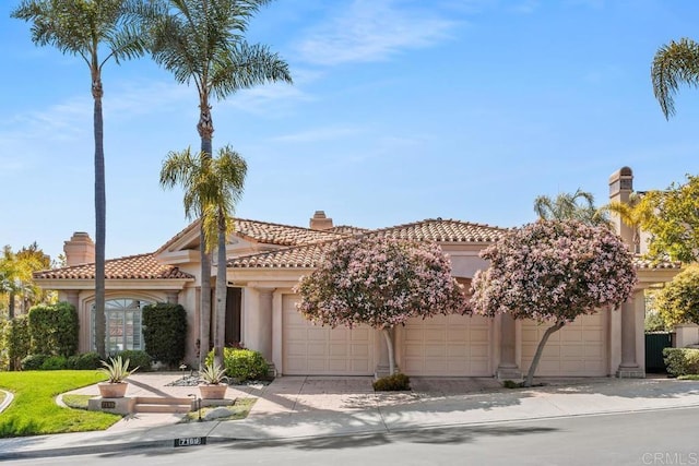 7189 Aviara Dr, Carlsbad, CA 92011 - mediterranean / spanish house with stucco siding, a chimney, a garage, and a tile roof