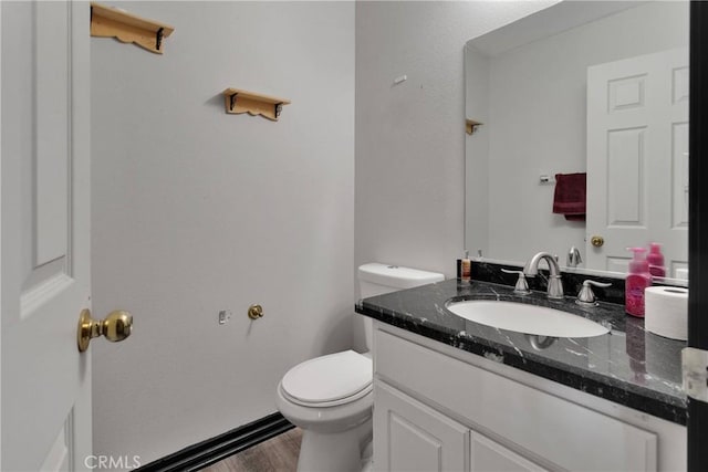 9153 Ravenswood Ave, Hesperia, CA 92344 - bathroom featuring toilet, vanity, and wood finished floors