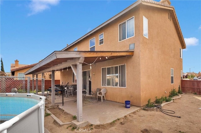 9153 Ravenswood Ave, Hesperia, CA 92344 - back of house featuring a patio area, stucco siding, and a fenced backyard