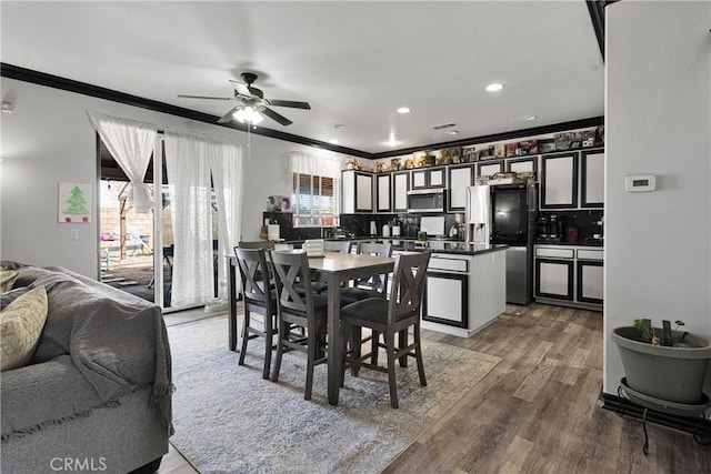 9153 Ravenswood Ave, Hesperia, CA 92344 - dining area featuring a ceiling fan, wood finished floors, ornamental molding, and recessed lighting