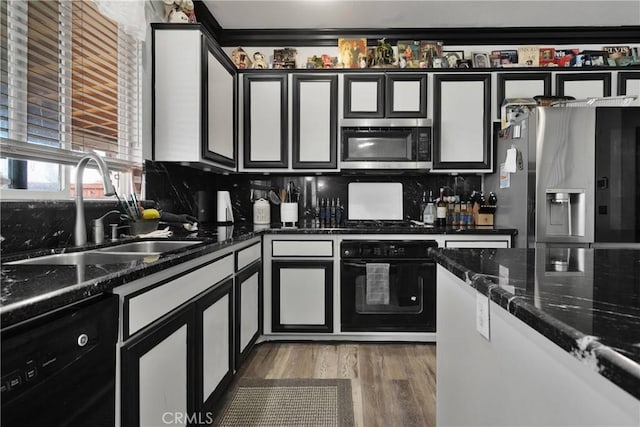 9153 Ravenswood Ave, Hesperia, CA 92344 - kitchen featuring tasteful backsplash, a sink, black appliances, and wood finished floors