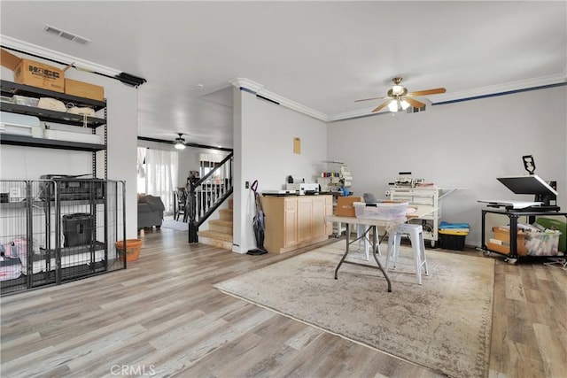 9153 Ravenswood Ave, Hesperia, CA 92344 - dining space featuring light wood finished floors, crown molding, ceiling fan, and visible vents