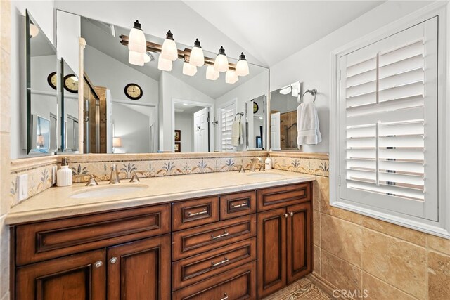 361 Cress St, Laguna Beach, CA 92651 - bathroom featuring vaulted ceiling, tile walls, double vanity, and tile patterned floors