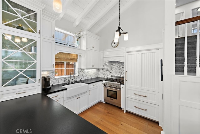 361 Cress St, Laguna Beach, CA 92651 - kitchen featuring stainless steel range, a sink, dark countertops, backsplash, and beamed ceiling