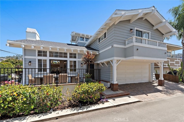361 Cress St, Laguna Beach, CA 92651 - view of front of property with a garage, decorative driveway, fence, a balcony, and a chimney