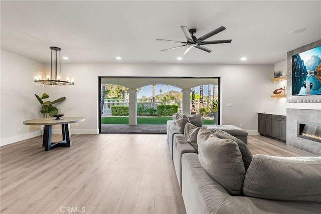 22883 Calcutta Dr, Canyon Lake, CA 92587 - living room featuring a tiled fireplace, decorative columns, a ceiling fan, recessed lighting, and light wood-style flooring