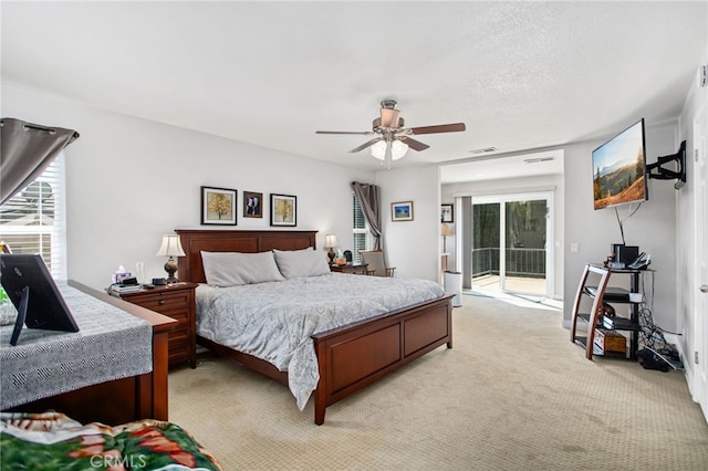 bedroom featuring ceiling fan, access to exterior, light carpet, and visible vents