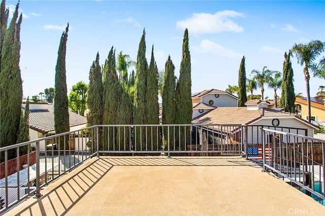 view of patio featuring an outbuilding and a balcony