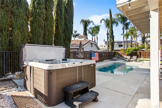 view of swimming pool with a patio area, a fenced in pool, a hot tub, and a fenced backyard