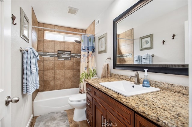full bathroom featuring visible vents, toilet, vanity, and shower / bath combo with shower curtain