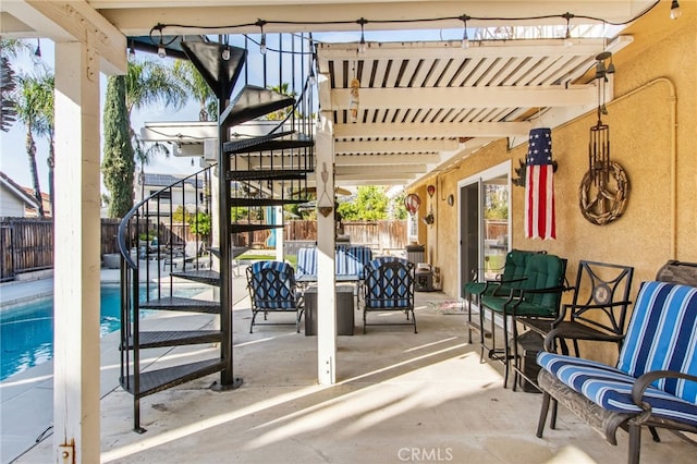 view of patio / terrace with fence, stairs, and a fenced in pool