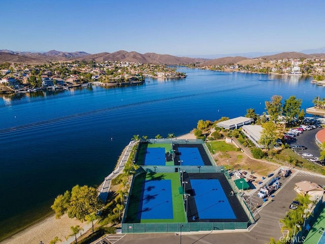 birds eye view of property with a water and mountain view