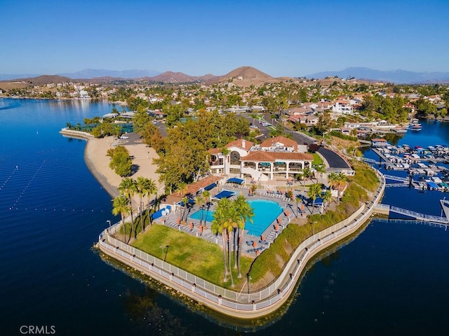 birds eye view of property with a water and mountain view
