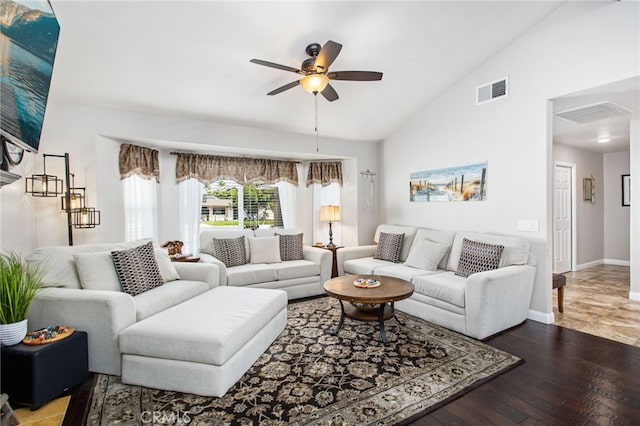 living area with vaulted ceiling, baseboards, visible vents, a ceiling fan, and wood finished floors