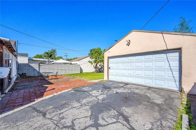 detached garage featuring fence