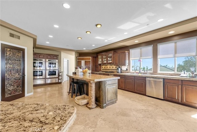 10817 Carriage Dr, Rancho Cucamonga, CA 91737 - kitchen featuring visible vents, recessed lighting, appliances with stainless steel finishes, and a breakfast bar area