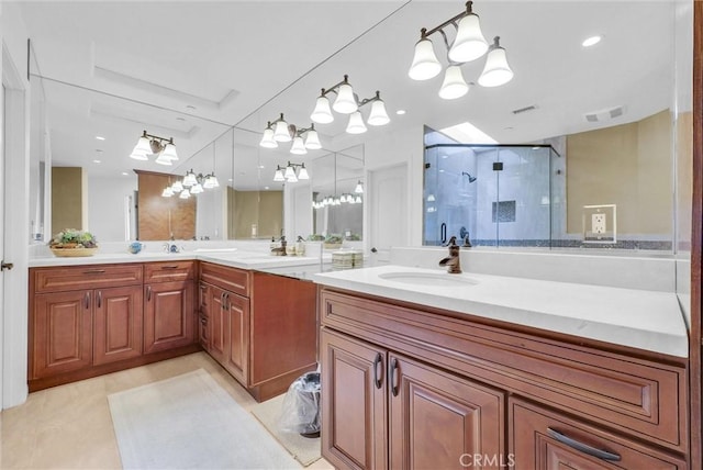 10817 Carriage Dr, Rancho Cucamonga, CA 91737 - bathroom featuring an inviting chandelier, double vanity, a shower stall, visible vents, and a sink