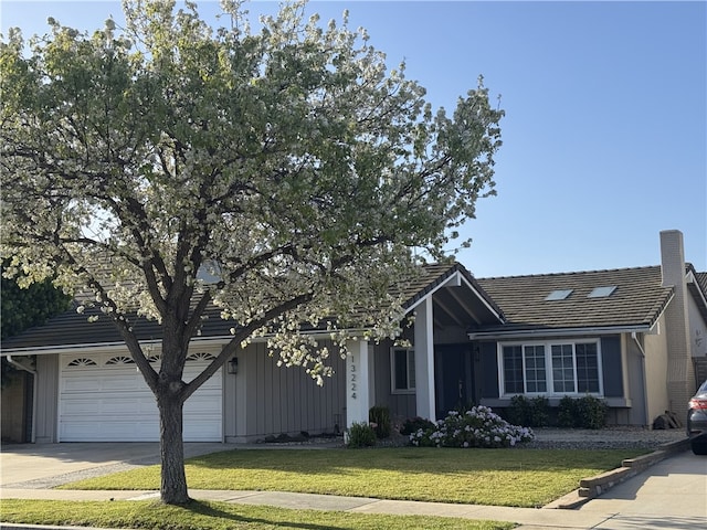 ranch-style house with driveway, board and batten siding, a tiled roof, and a front yard