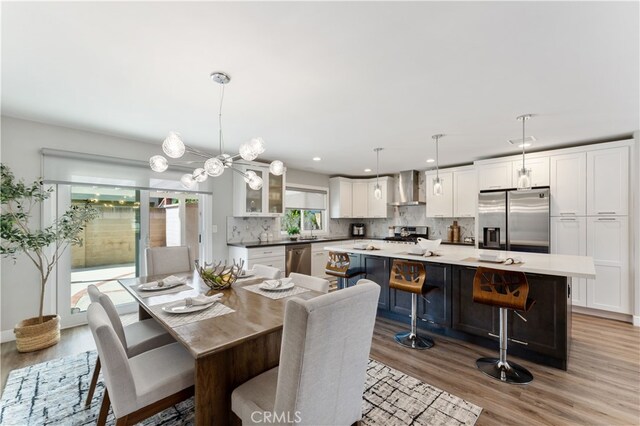 dining space featuring light wood-style floors and recessed lighting