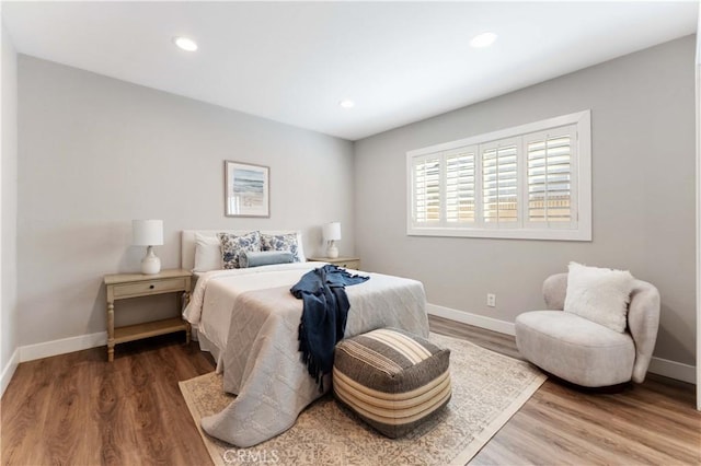 bedroom with baseboards, recessed lighting, and wood finished floors