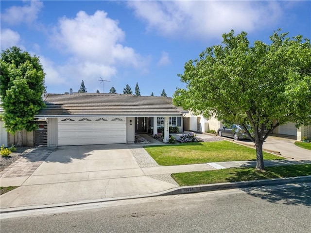 single story home with an attached garage, driveway, a tile roof, and a front lawn
