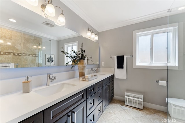 full bath featuring double vanity, visible vents, ornamental molding, and a sink