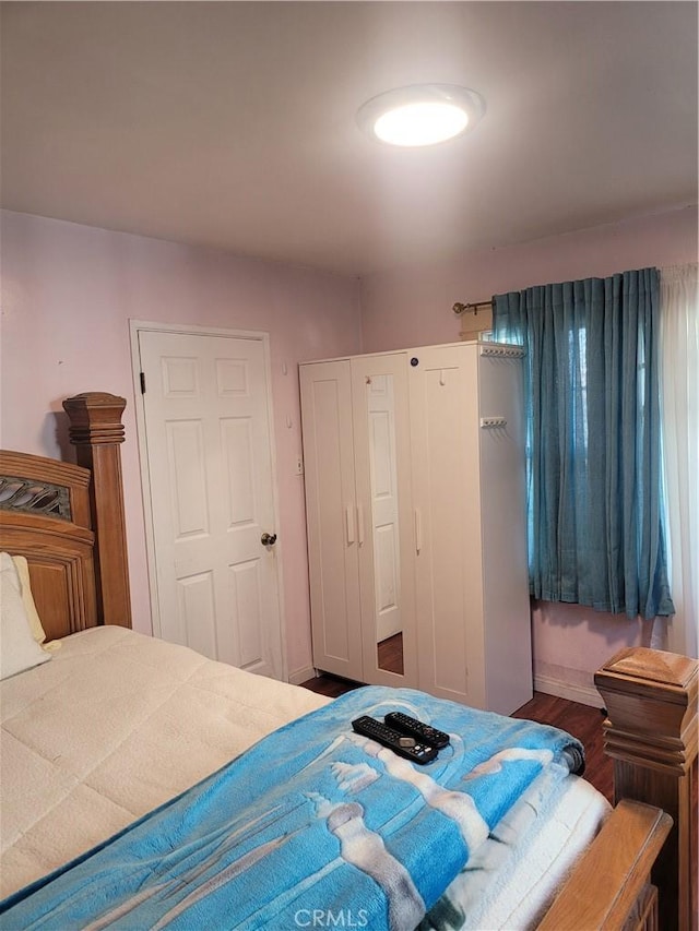 bedroom with a closet and wood finished floors