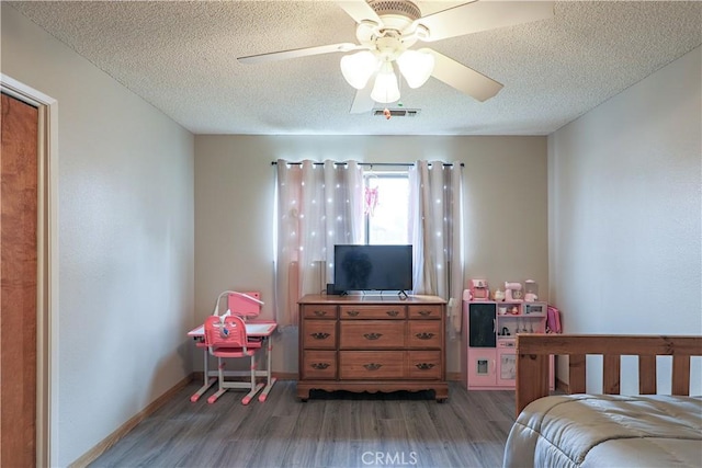 bedroom with a textured ceiling, light wood finished floors, ceiling fan, and visible vents