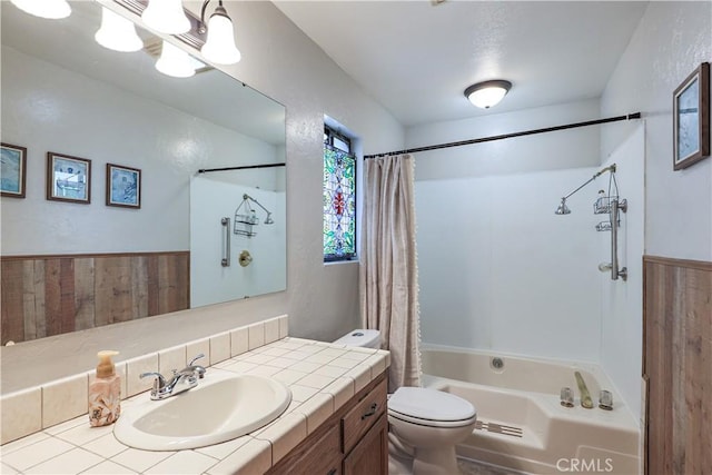 bathroom featuring toilet, vanity, and shower / bathtub combination with curtain